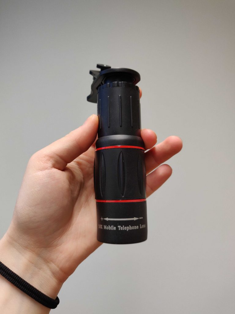 A person holding monocular