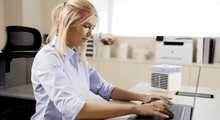 A women using NexFan Ultra while working