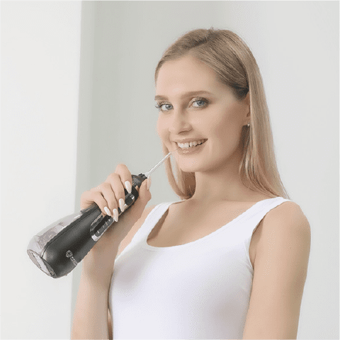 A girl with her Waterpulse Tooth Cleaner