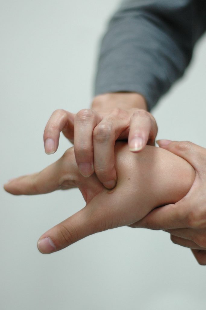 Pressing acupressure points on hand
